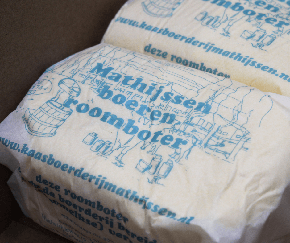 Eigengemaakte boeren roomboter in bedrukt papieren omhulsel